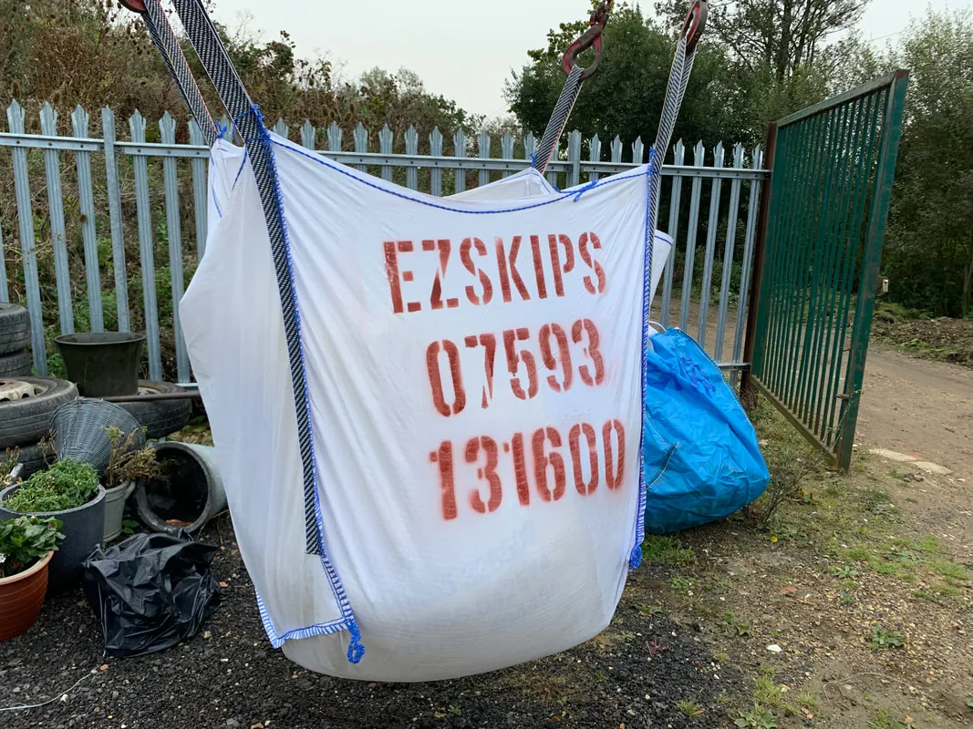 A white EZSKIPS skip bag lifted by its straps