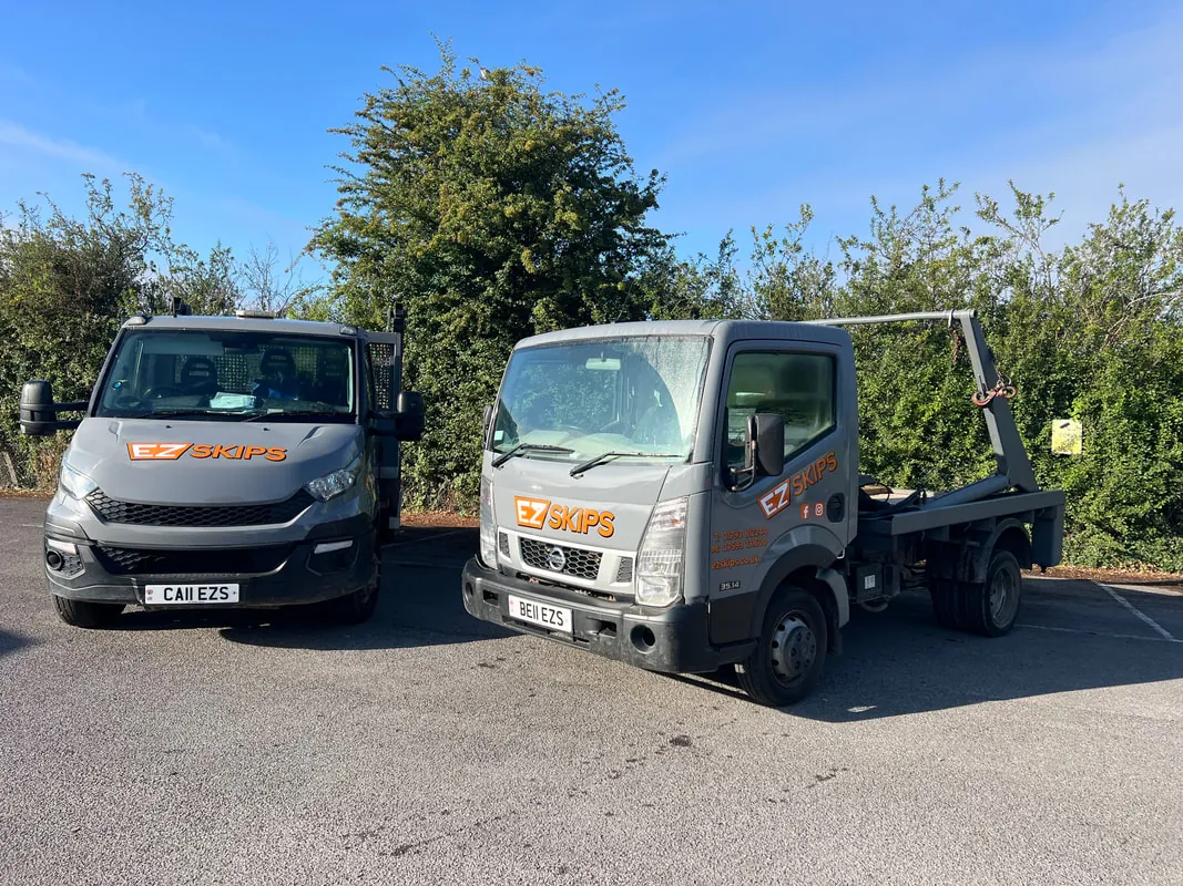 Two grey EZSKIPS lorries seen from the front